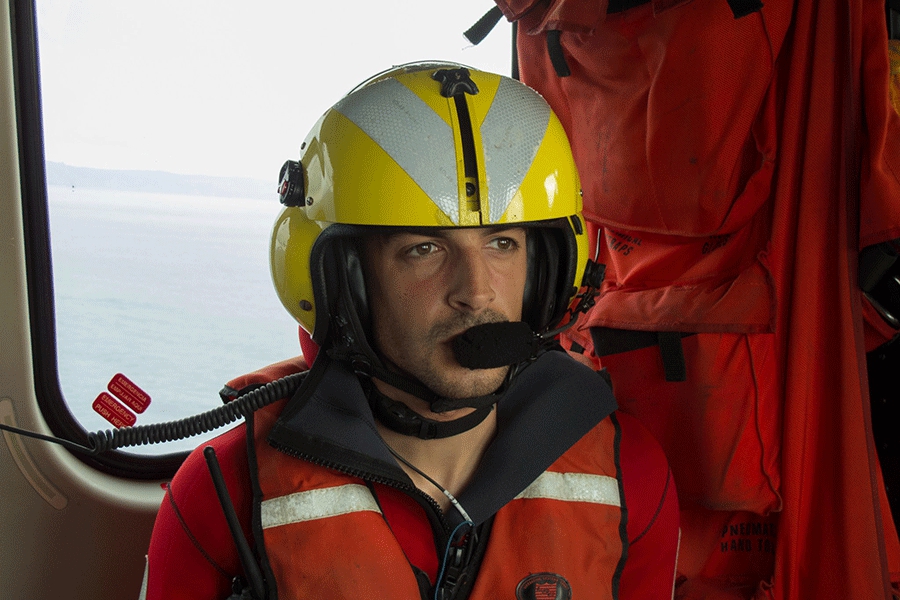 Hard work: a helicopter rescuer looks out to sea. Credit: Spanish Coast Guard