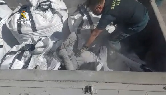 Guardia Civil rescue man from sack containing toxic waste