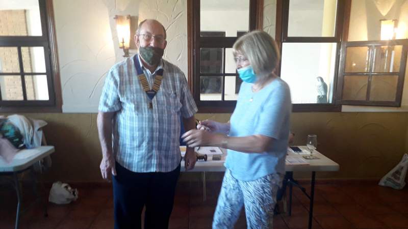 Lions President Graham Rutland presents the diamond pin to Rosemary Brabrook