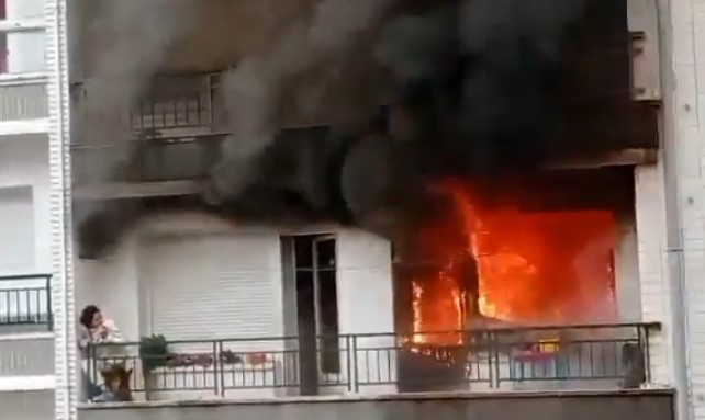 Dramatic rescue of woman trapped on 5th floor balcony as flames destroy her home
