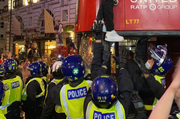 Riot police manned Trafalgar square after football fans vented their anger over England's defeat