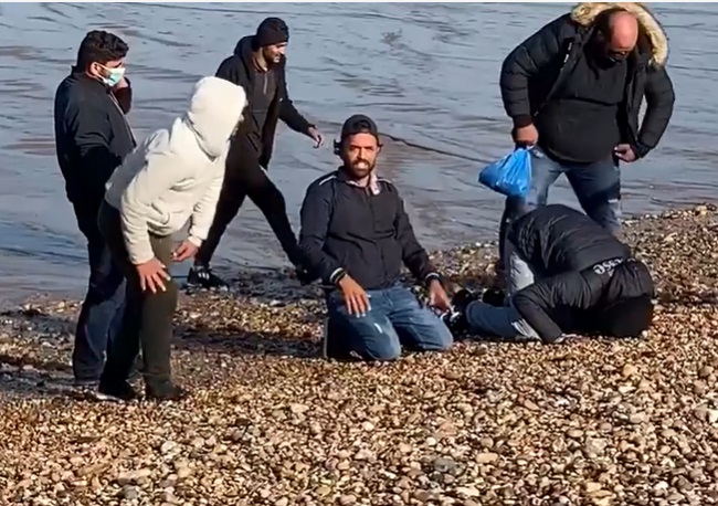 Desperate migrants kiss British soil after making perilous trip across the Channel