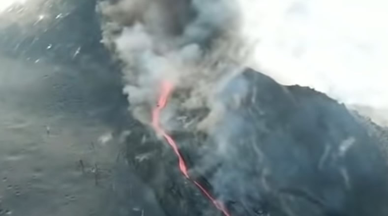 Cone of La Palma volcano breaks spewing a stream of lava