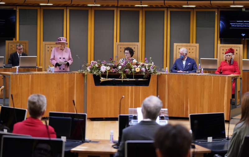 The Queen looks pretty in pink as she opens Welsh Parliament
