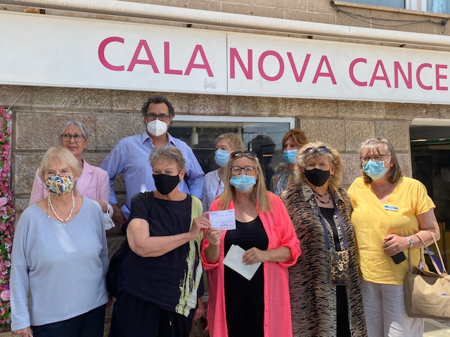 Receiving a cheque from Cala Nova Cancer Shop