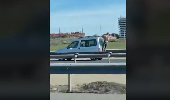 WATCH: Semi-naked man arrested for clinging onto a moving van in Madrid