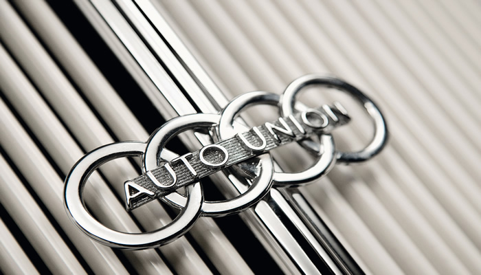 How did the famous four-ring Audi logo originate?