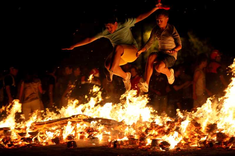 Image of people jumping over a San Juan bonfire.