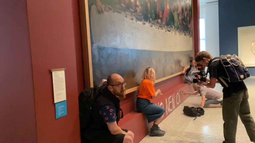 Climate protesters glue themselves to Leonardo da Vinci masterpiece in London
