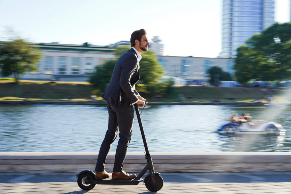 Image of man riding an electric scooter.