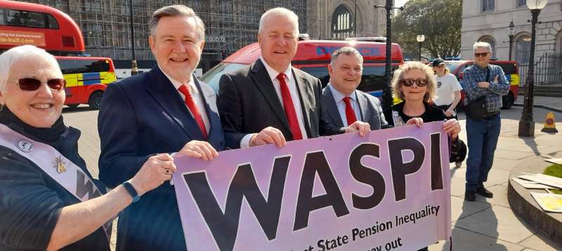 Three MPS outside the Houses of Parliament supporting WASPI