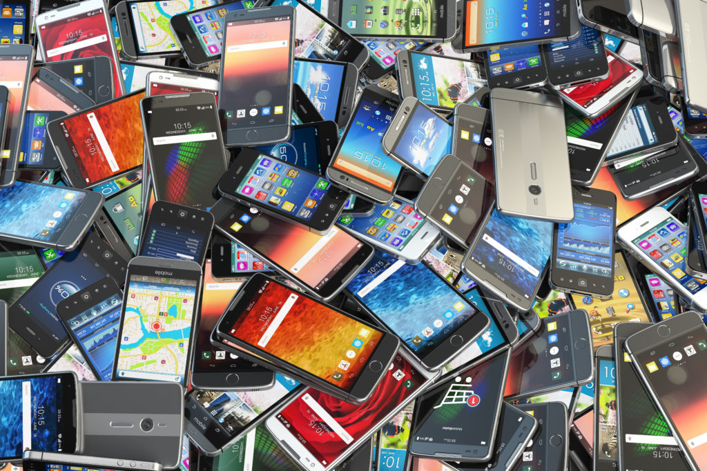 A pile of assorted mobile phones