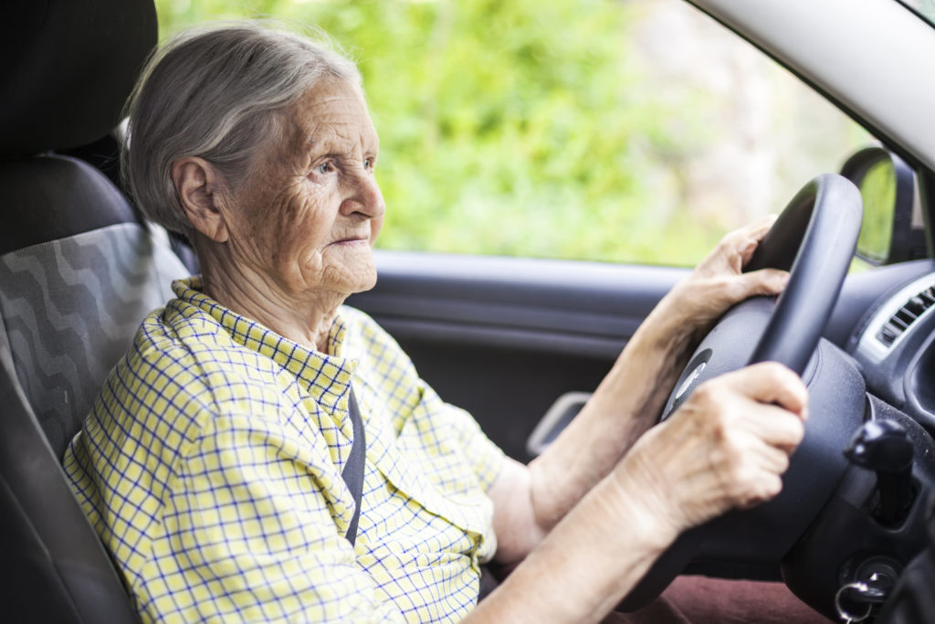 Image of a pensioner driving a car.