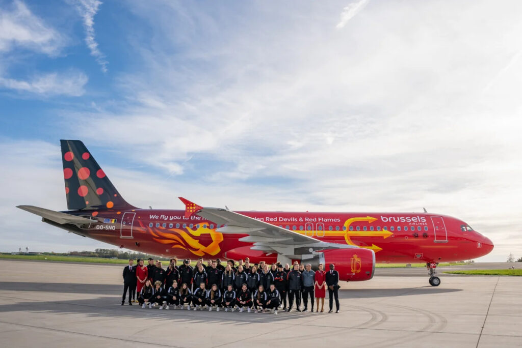 The teams pose in front of the new aircraft