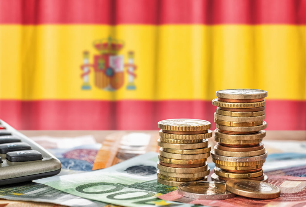 Image of Euros with a Spanish flag in the background.