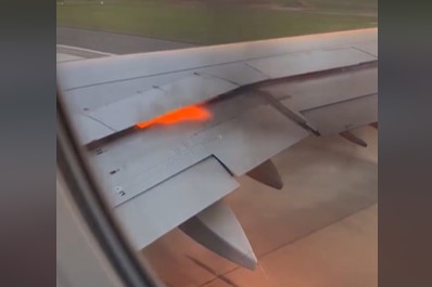Plane engine bursts into flames on runway as passengers evacuated  