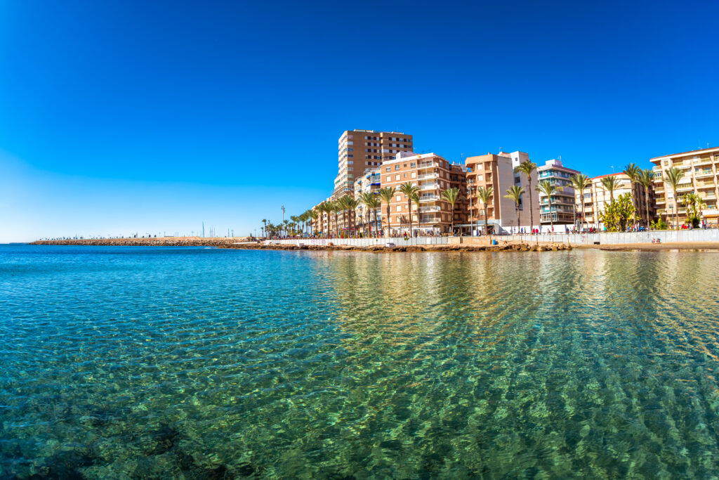 view of Torrevieja's blue mediterranean waters and modern coastal buildings