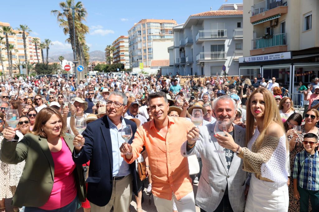 authorities raise their glasses of wine in a toast to Torrox at a wine festival