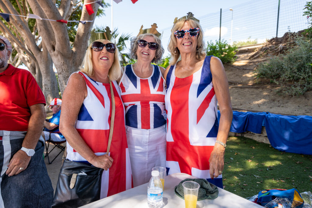three women dressed in union jack flag outfits.