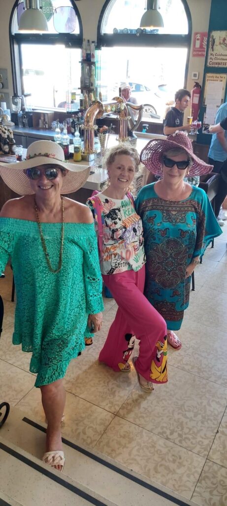 three models pose in their outfits at the Age Concern fashion show