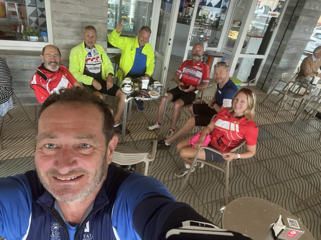 the cyclists from the group enjoy a coffee during the ride
