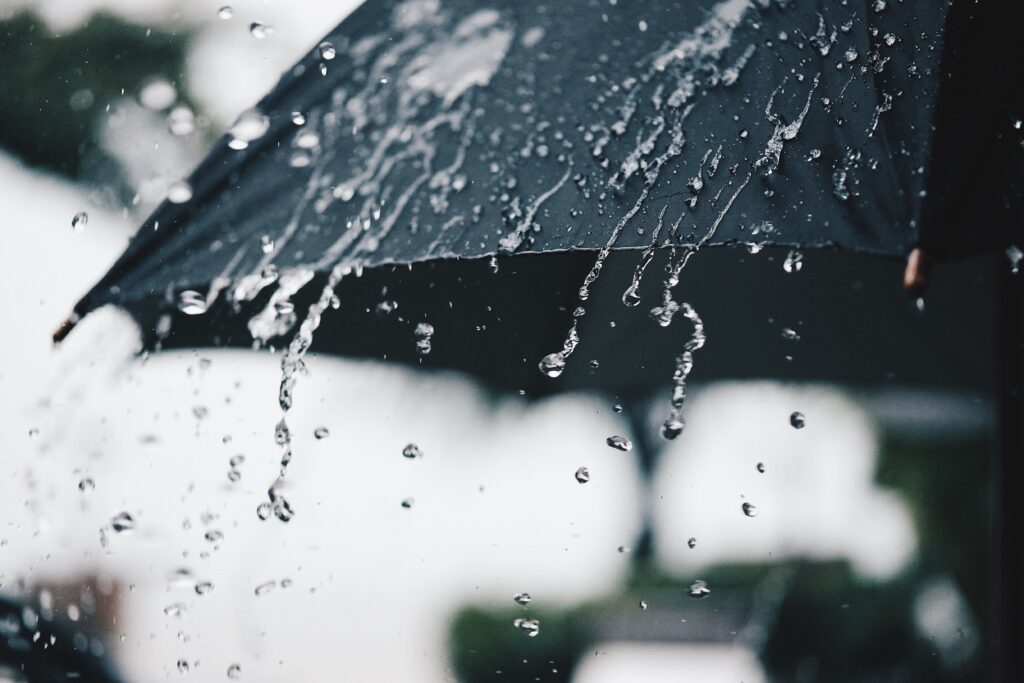 Image of rain falling on an umbrella.