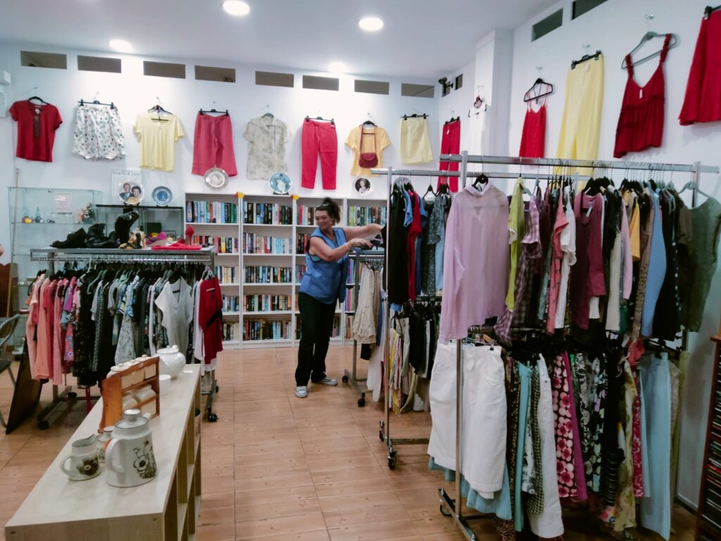 A volunteer organises stock in the refurbished charity shop.