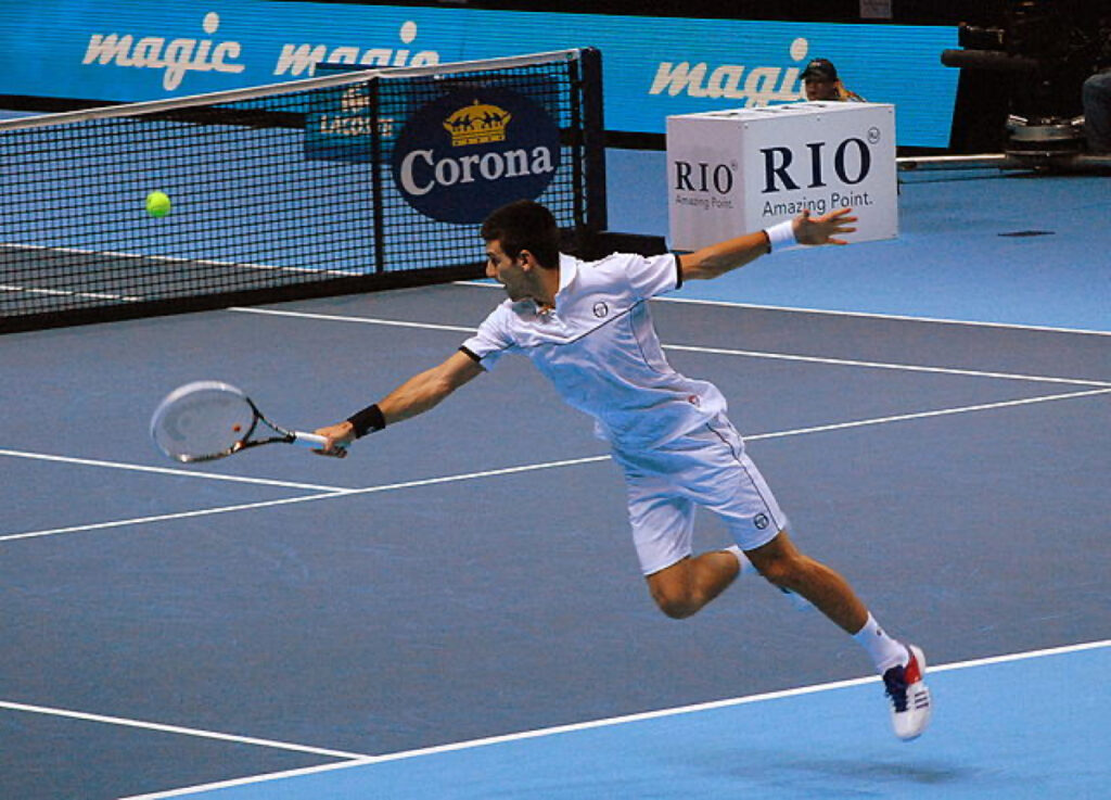 Novak Djokovic stretches for the ball in a typically athletic return