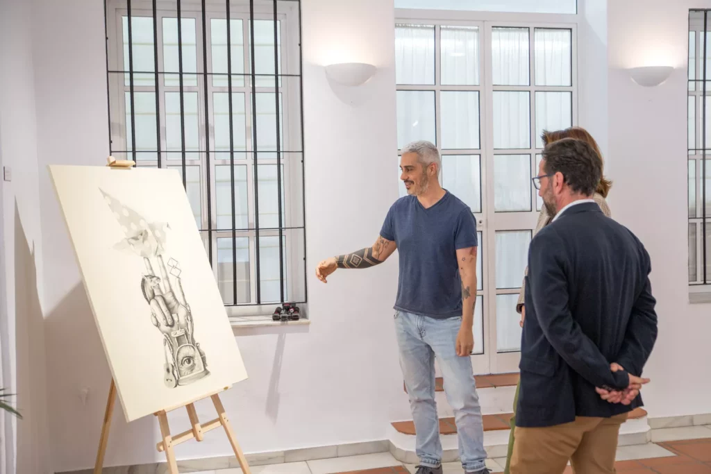 artist shows easel to guests