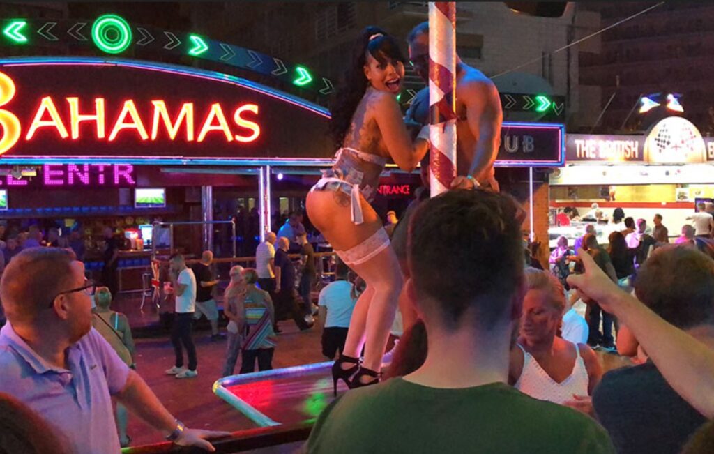 Image of a girl dancing on a podium in Benidorm.