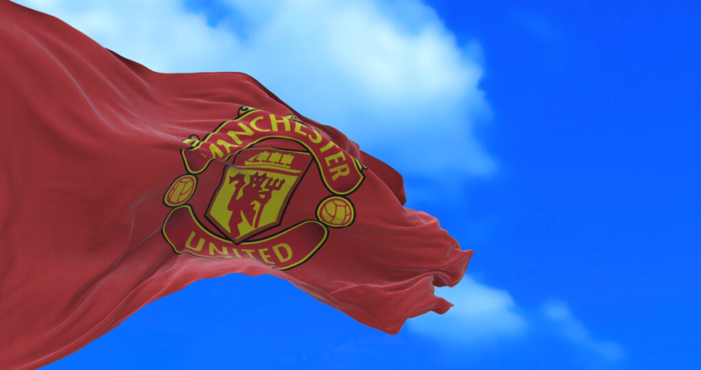 A flag with Manchester United's badge blowing in the wind.