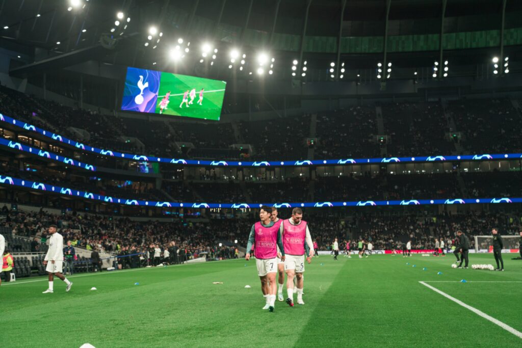 Spurs players warming up at the Tottenham Hotspur Stadium.