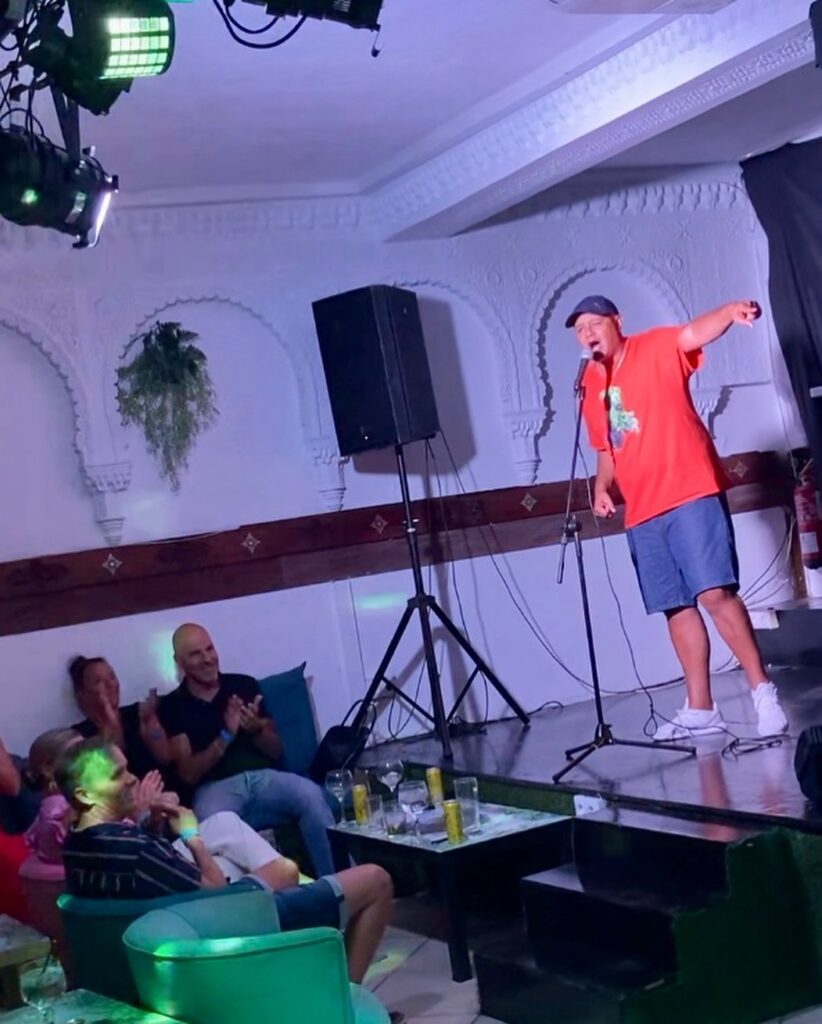 man on stage at comedy