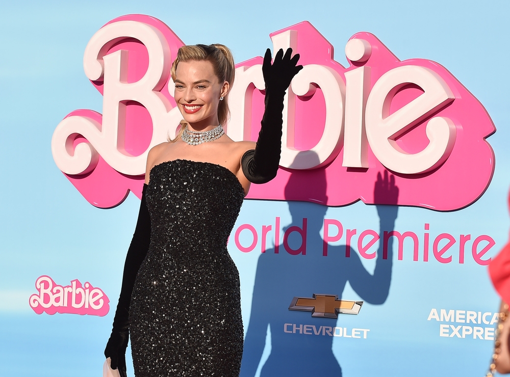 View of Margot Robbie at the Barbie Movie Premiere, waving on the pink carpet
