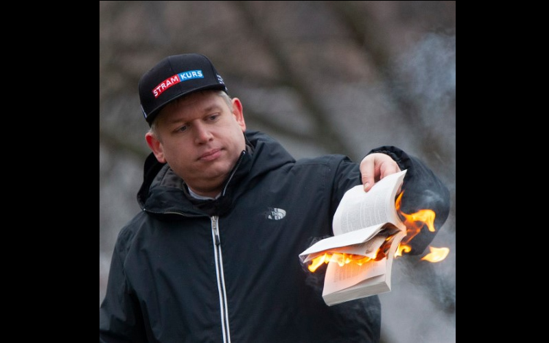 Image of a Koran being burned by politician Rasmus Paludan.