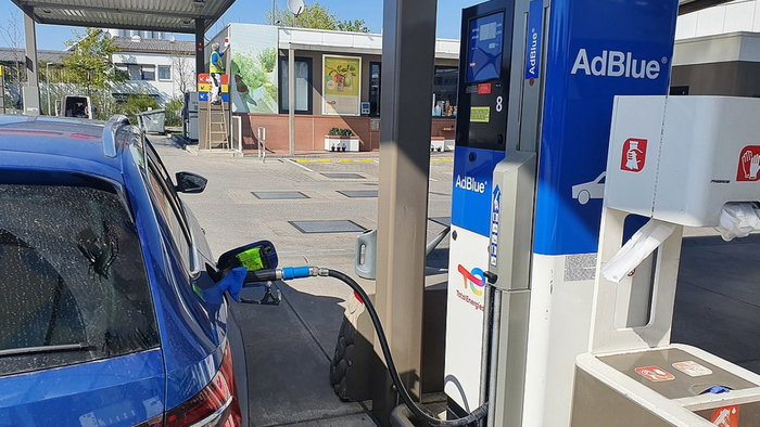 Image of a driver putting AdBlue in a vehicle.