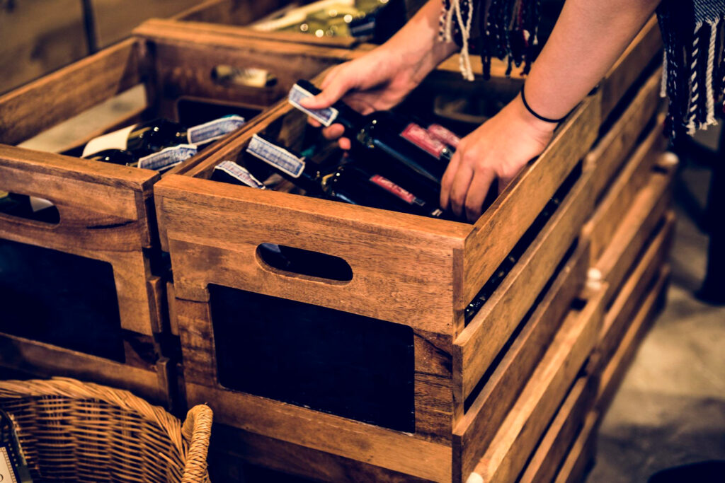 A person retrieving wine from a box