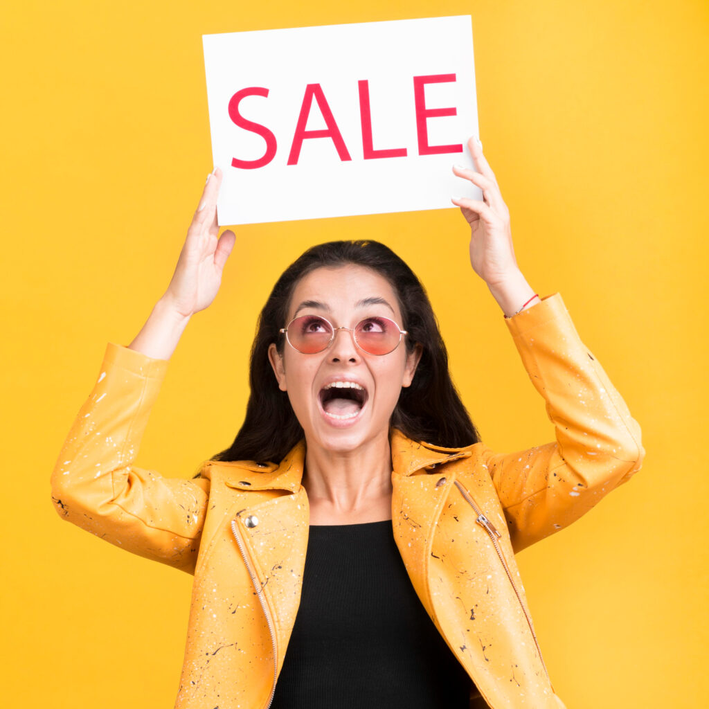 Woman holding a sale sign