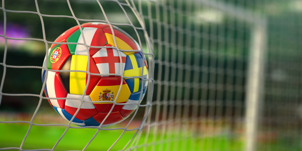 Image of a football going into the net.