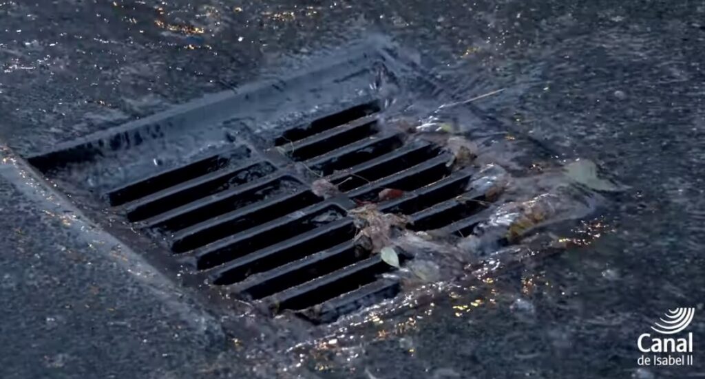 Image of rainwater going down a drain.