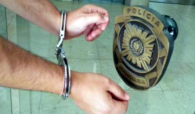 Image of suspect in police handcuffs in Portugal.