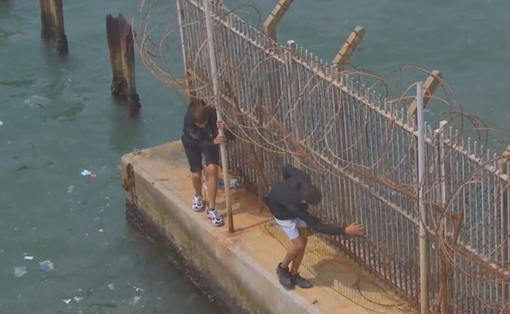 CCTV image of two teenagers entering Gibraltar illegally through the border fence.