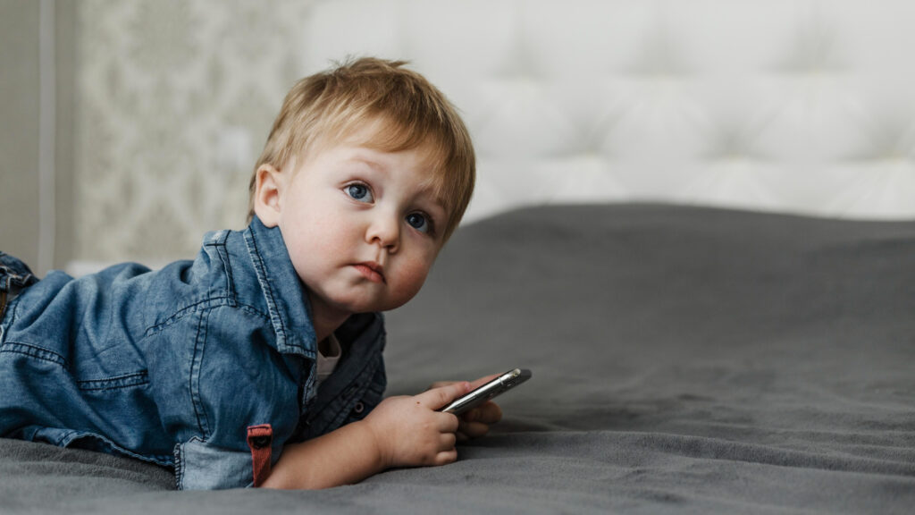 A baby holding a mobile phone
