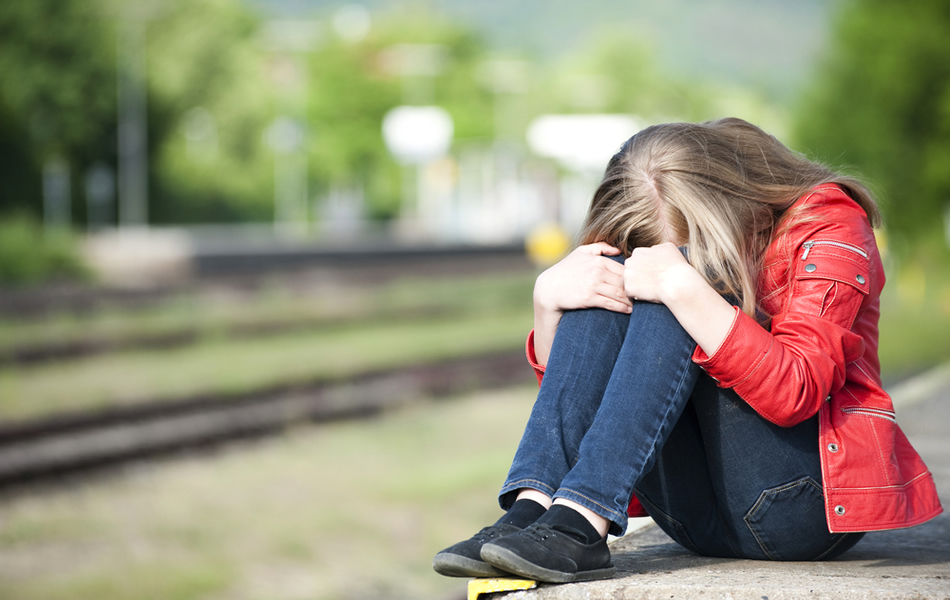 Image of a depressed young girl.