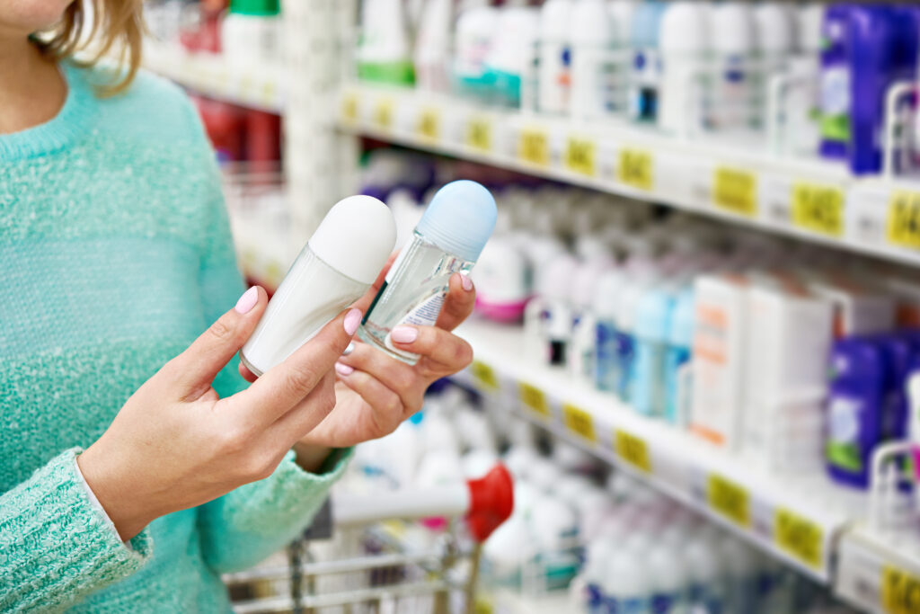 A woman choosing which deodorant to purchase