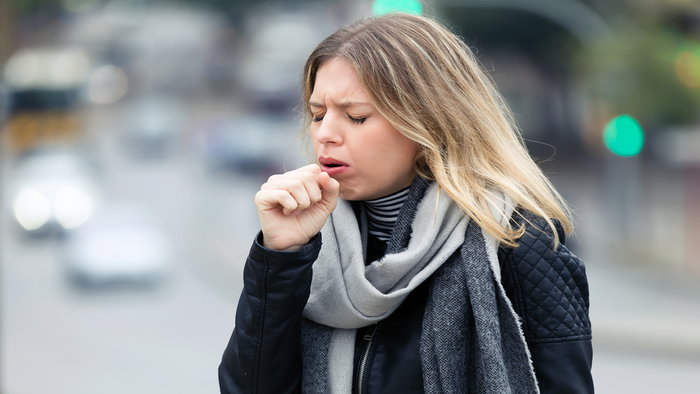 Image of a girl coughing.