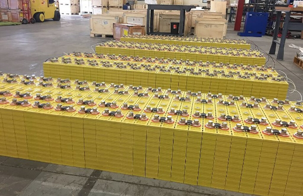 Image of lithium battery cells in a warehouse.