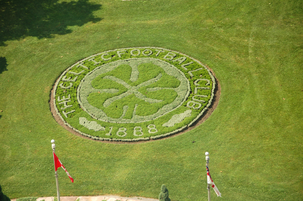 Picture of a green grass area with a crommemorative design of Celtic football club logo