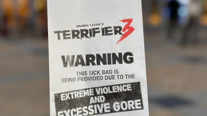Photo of a poster for Terrifier 3 warning of vomiting during the film