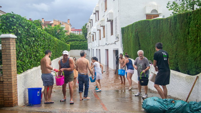 Moroccan workers in Valencia clearing mud and debris from sewers following severe floods.